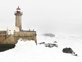 Lighthouse on Stormy Coast with Crashing Waves
