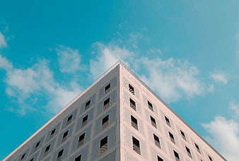 Low angle view of modern library building against blue sky