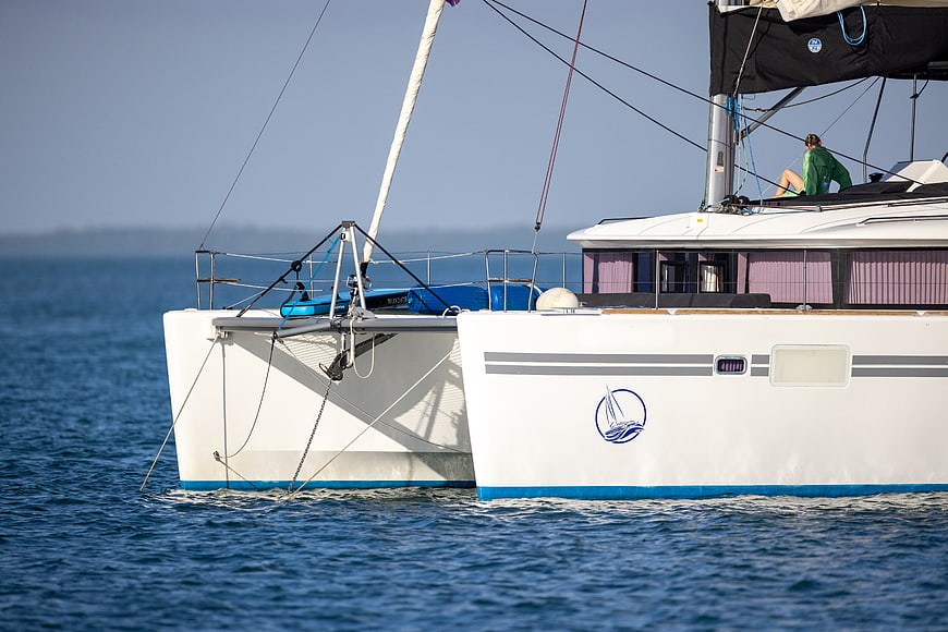 White Catamaran Sailboat Cruising on Blue Sea