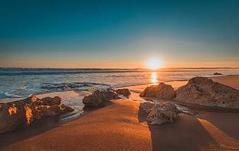 Golden Sunset Over Rocky Beach in Algarve Portugal
