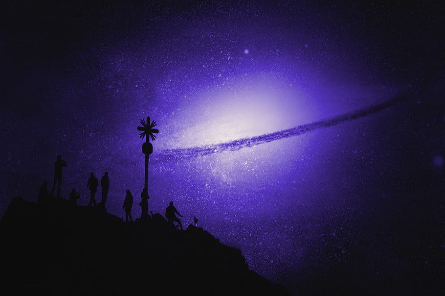 Silhouetted Hikers on Mountain Peak Under Milky Way