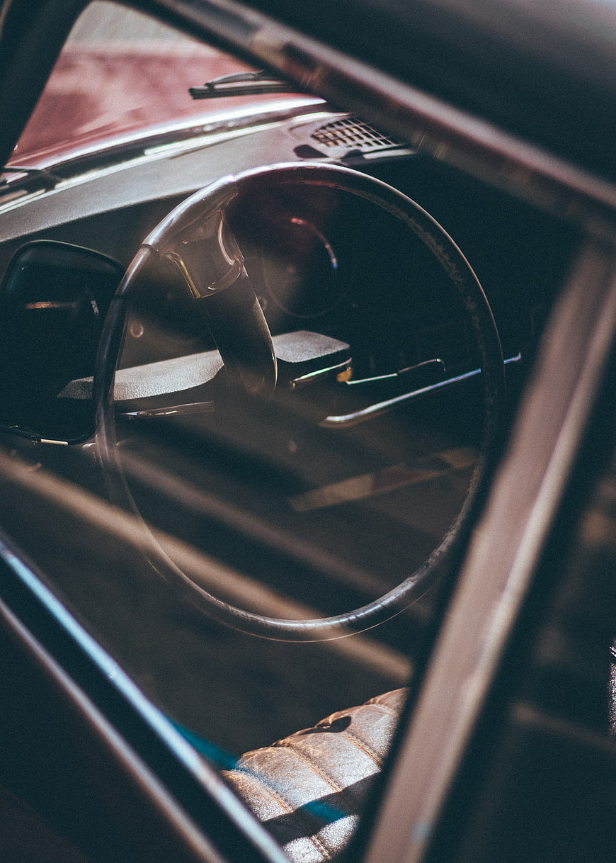 Vintage car interior with steering wheel and dashboard