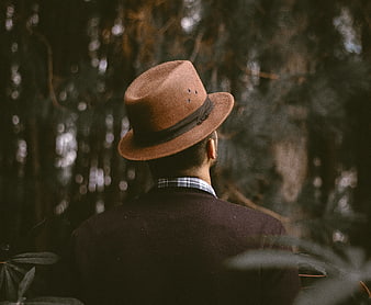 Man in Fedora Hat Standing in Dark Forest
