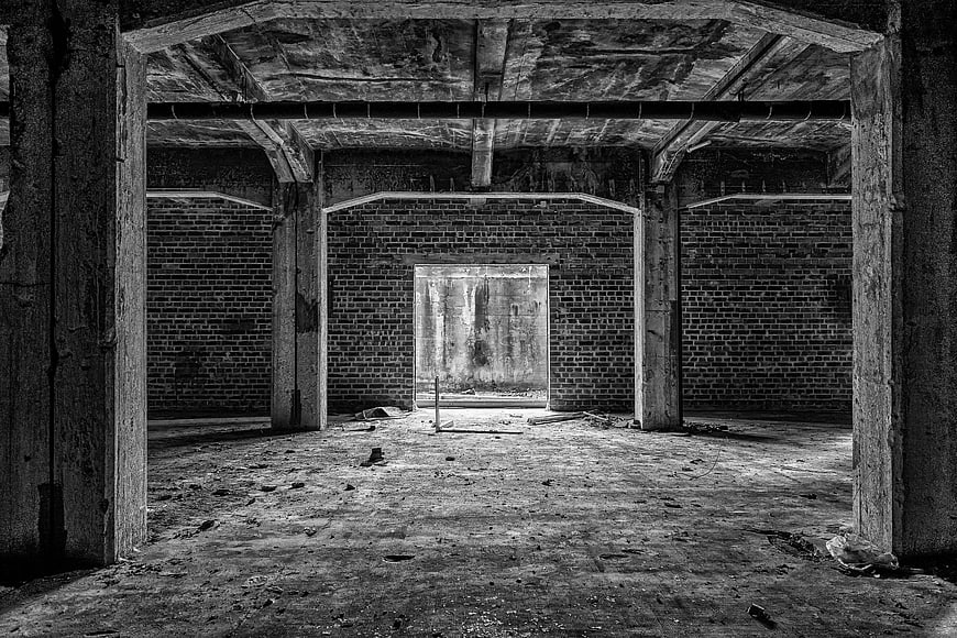 Abandoned Underground Brick Cellar Interior In Black And White
