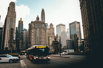 Chicago skyline with moving bus and taxi on city street