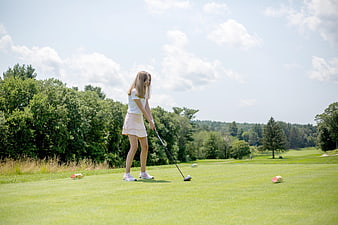 Young Woman Playing Golf on a Sunny Summer Course