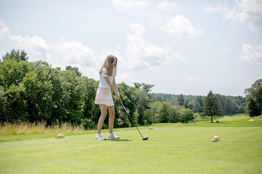 Young Woman Playing Golf on a Sunny Summer Course
