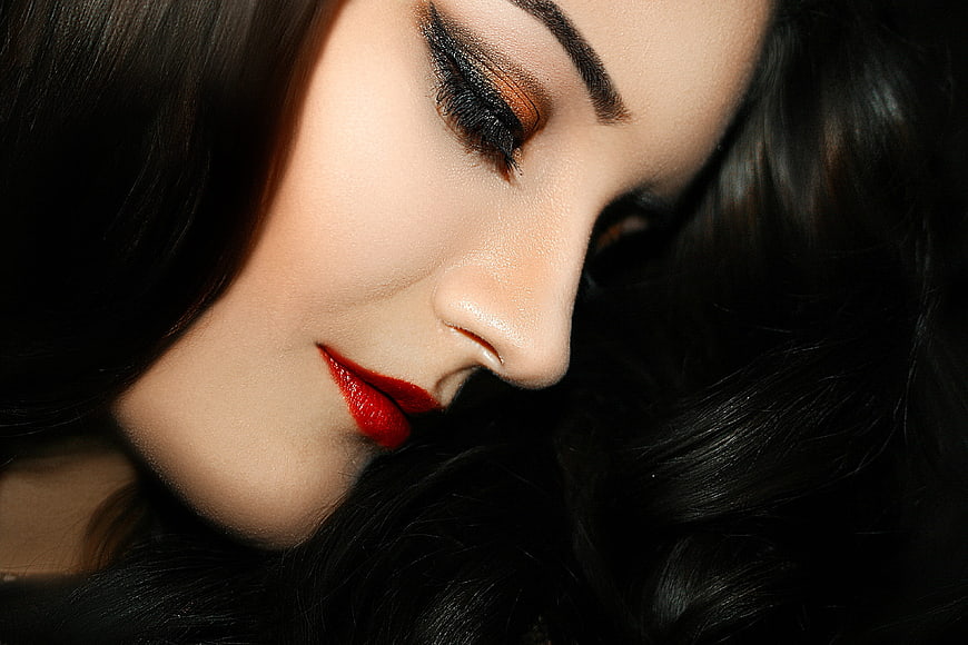 Close-up portrait of woman with red lips and dark hair