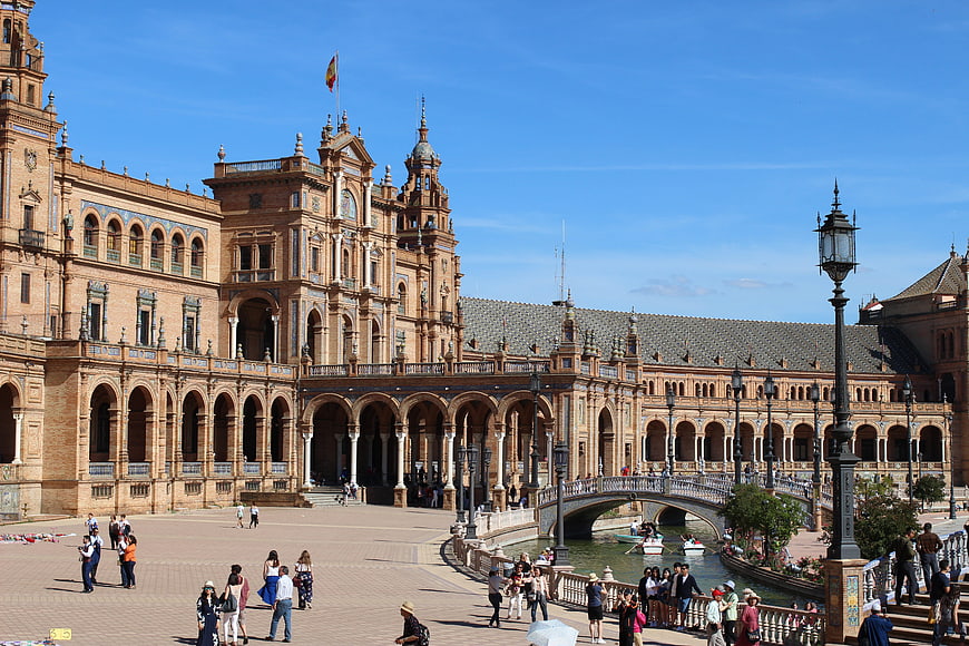 Plaza de España in Seville, Spain with tourists and canal