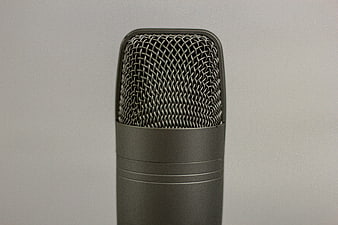 Close-up of a professional studio microphone on gray background