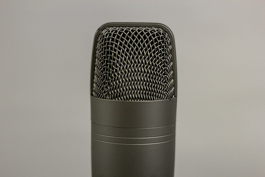 Close-up of a professional studio microphone on gray background