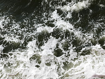 Aerial View of Turbulent Ocean Waves and White Sea Foam