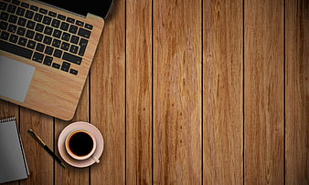 Flat lay workspace with laptop, coffee, and notebook on wood