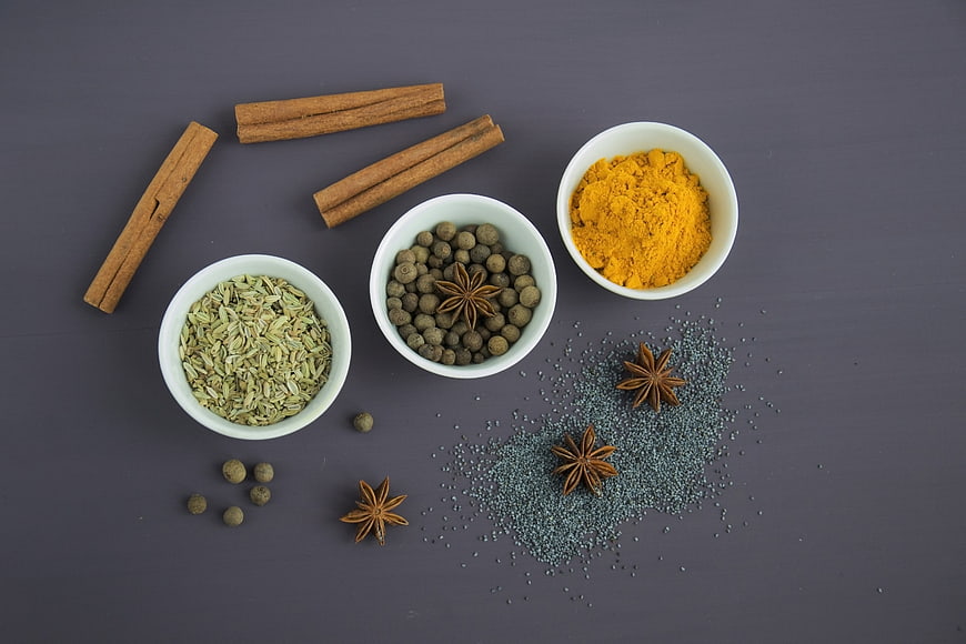 Top View of Spices in White Bowls on Gray Background