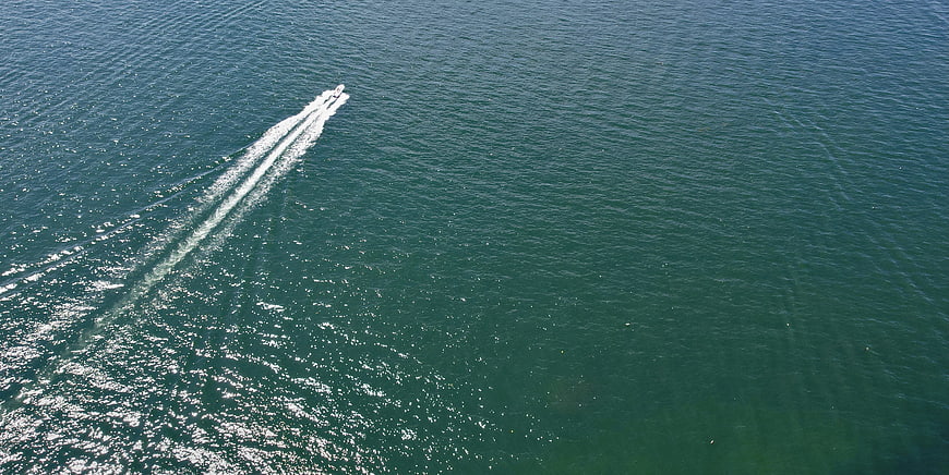 Aerial View of Speedboat Leaving White Wake on Blue Sea