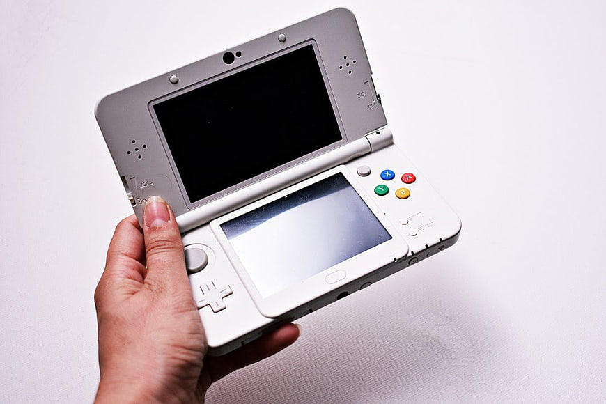 Hand Holding White Nintendo 3DS Game Console