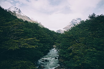 Majestic Mountain River Valley with Snow-Capped Peaks