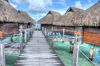 Tropical Overwater Bungalows With Wooden Walkway And Turquoise Lagoon