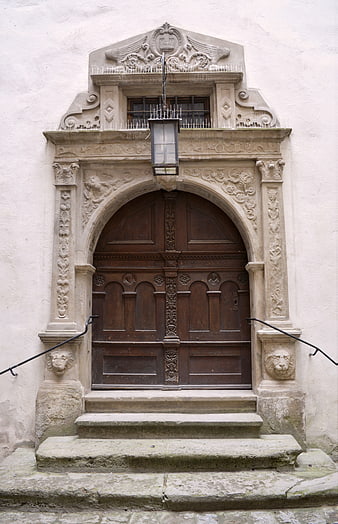 Ornate Historic Stone Entrance with Wooden Door