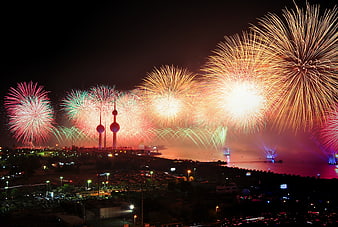 Spectacular fireworks display over Kuwait City skyline at night