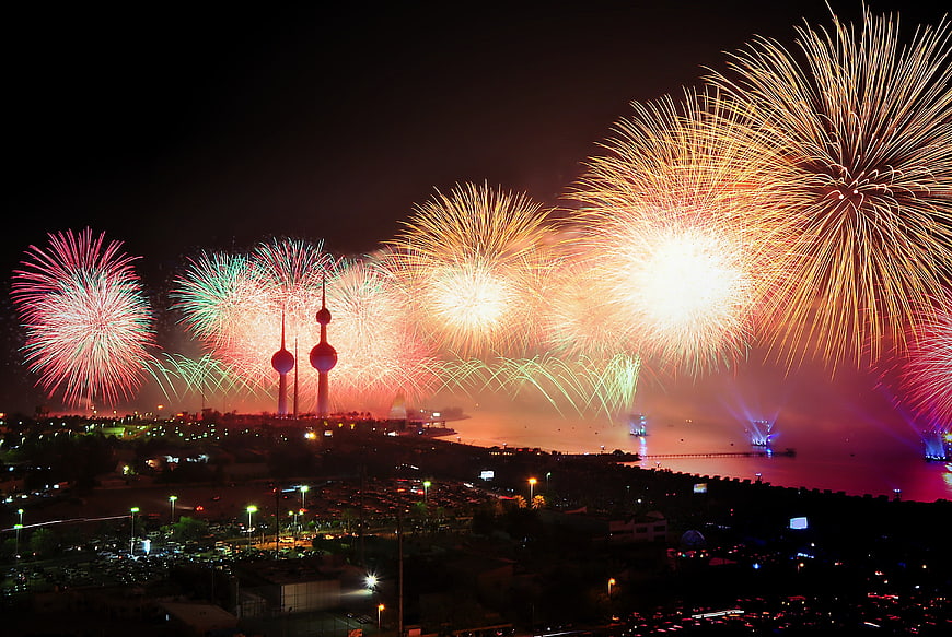 Spectacular fireworks display over Kuwait City skyline at night