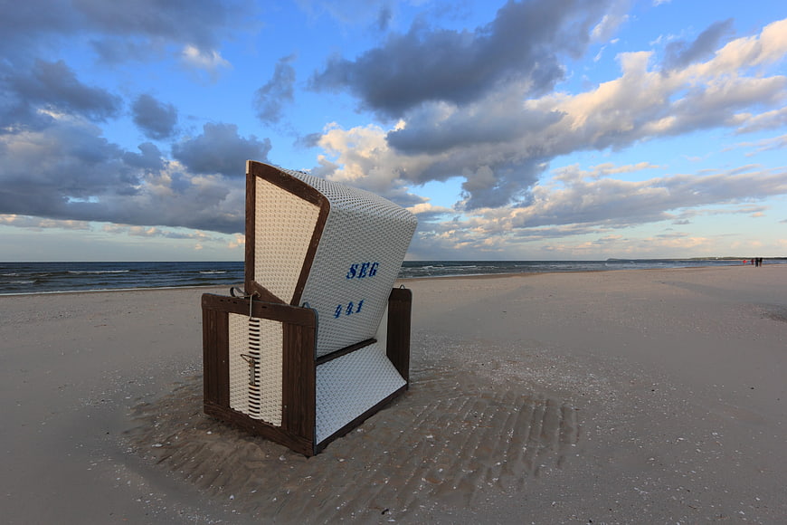 Traditional German Beach Chair on Sandy Shore at Dusk