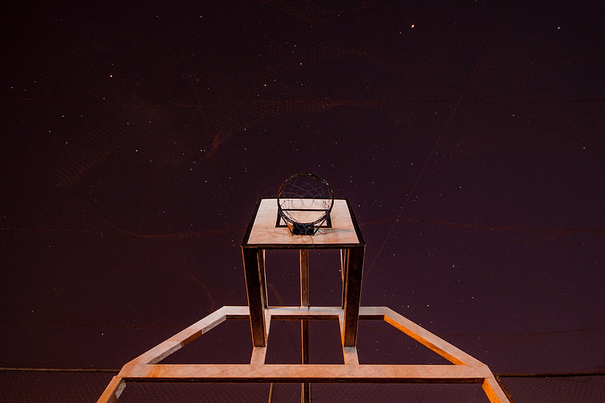 Low angle view of basketball hoop against starry night sky