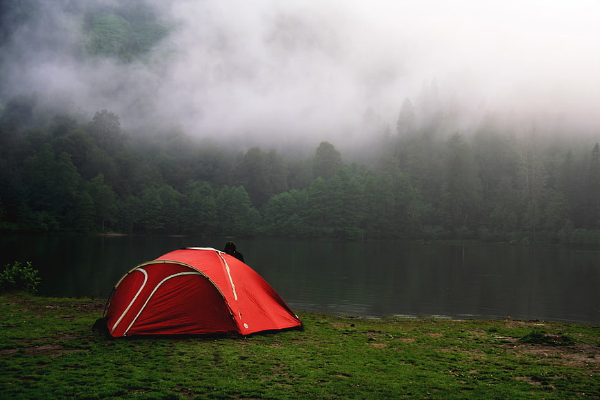 Red Tent Camping by Misty Forest Lake