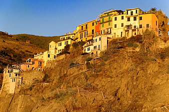 Colorful Mediterranean Village on Rocky Cliffside at Sunset
