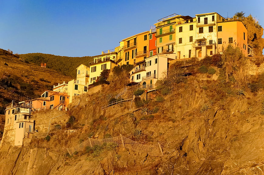 Colorful Mediterranean Village on Rocky Cliffside at Sunset