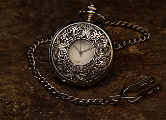 Vintage Silver Pocket Watch with Chain on Rustic Background