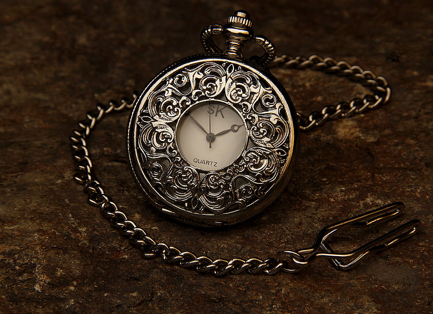 Vintage Silver Pocket Watch with Chain on Rustic Background