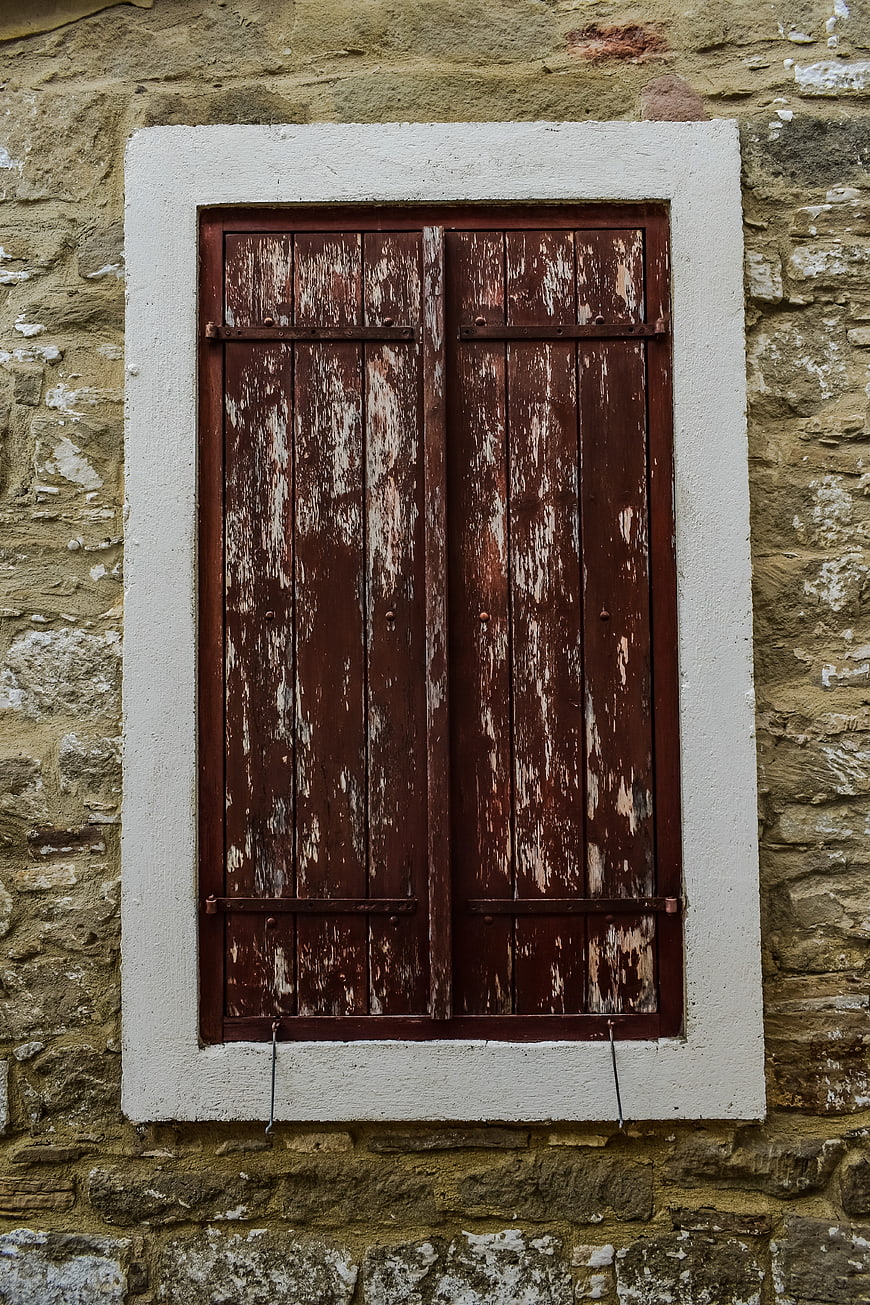 Weathered Wooden Shutters on Old Stone Wall