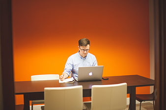 Businessman working on laptop and notebook in modern office