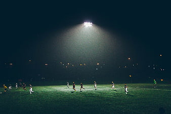 Night Football Match Under Stadium Floodlights