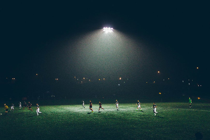 Night Football Match Under Stadium Floodlights