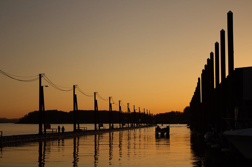 Silhouetted Pier and Boats at Golden Sunset