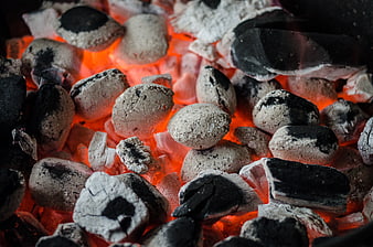 Glowing charcoal briquettes for barbecue grill