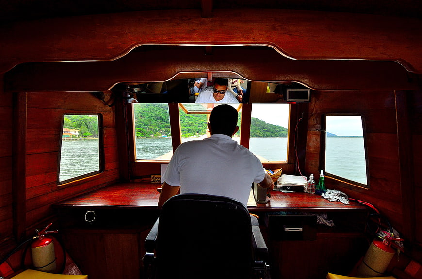 Boat Captain Steering from Wooden Cabin Interior