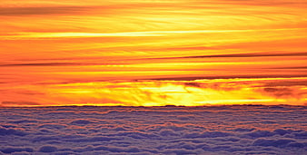 Vibrant Orange Sunset Above Sea of Clouds