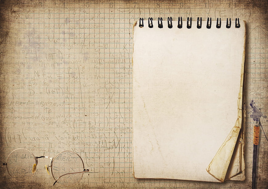 Vintage Notepad With Glasses And Pen On Mathematical Graph Paper
