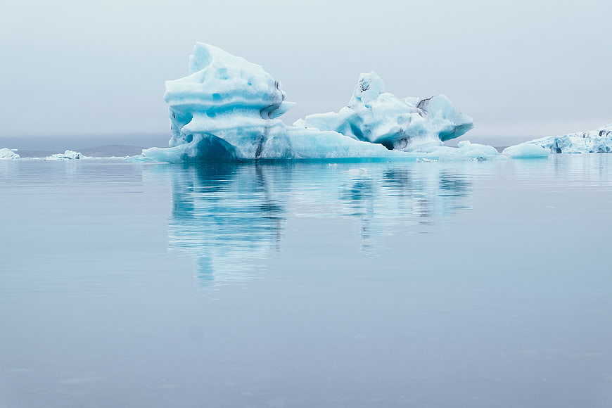 Serene Blue Iceberg Floating in Calm Arctic Waters