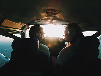 Couple Flying in Small Airplane Cabin at Sunset