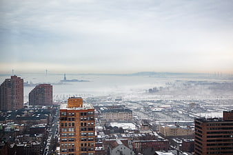 Foggy Winter Cityscape with Statue of Liberty and Bridge