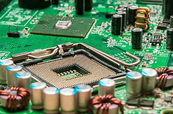 Close-up of computer CPU socket and green circuit board components