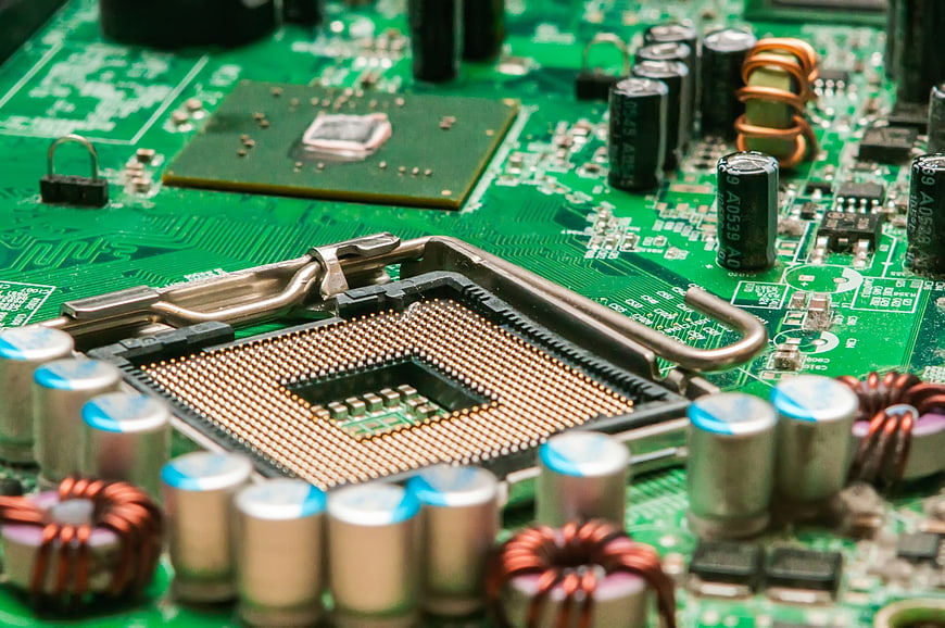 Close-up of computer CPU socket and green circuit board components