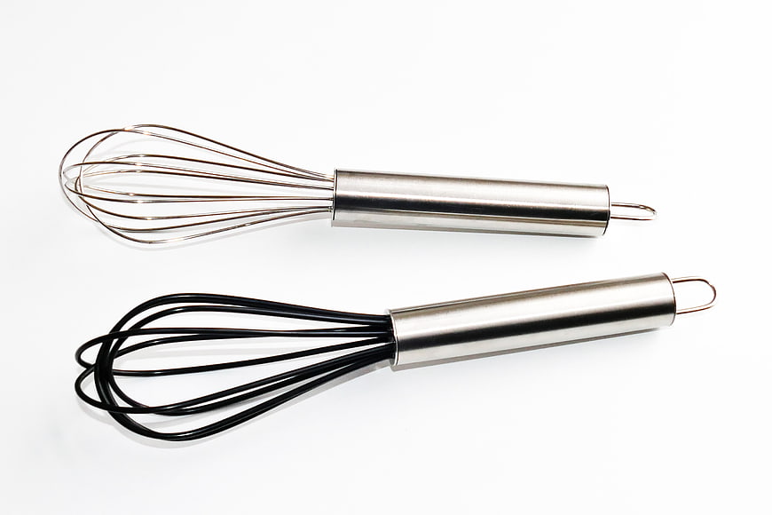 Stainless Steel and Silicone Kitchen Whisks on White Background