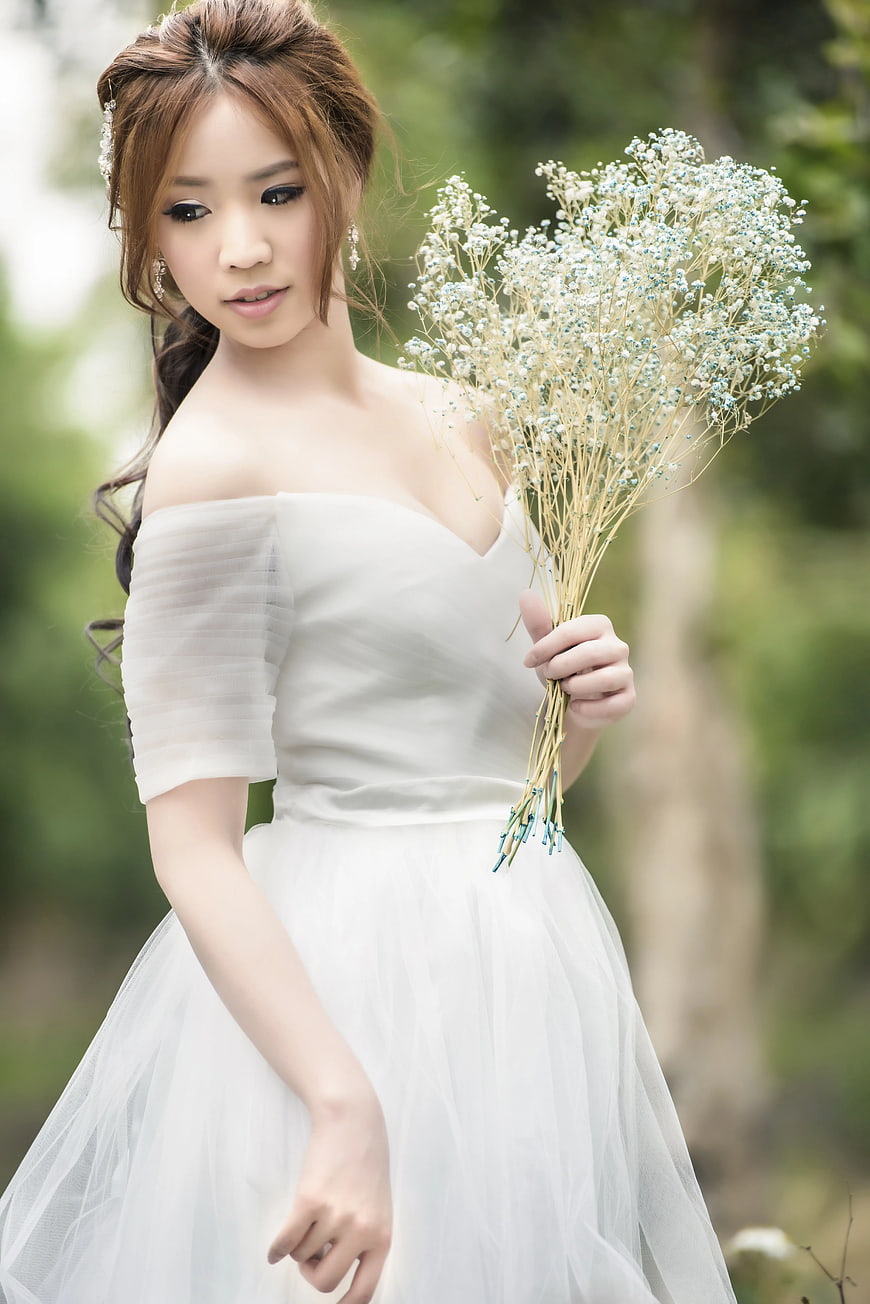 Bride in White Dress Holding Baby's Breath Bouquet