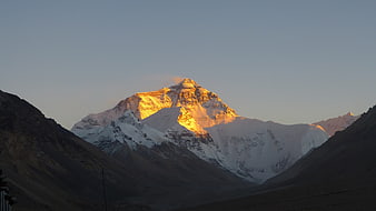 Sunset Illuminating Snow-Capped Mountain Peak In Tibet