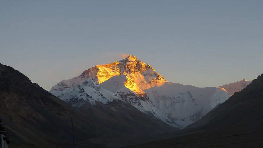 Sunset Illuminating Snow-Capped Mountain Peak In Tibet